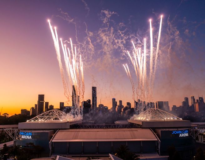 Fireworks over Melbourne Park stadium at dusk