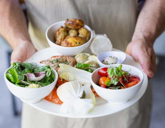 Big plate of fresh, delicious food being held