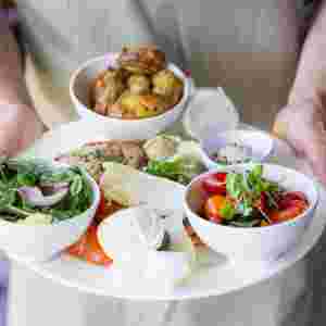 Big plate of fresh, delicious food being held