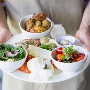 Big plate of fresh, delicious food being held