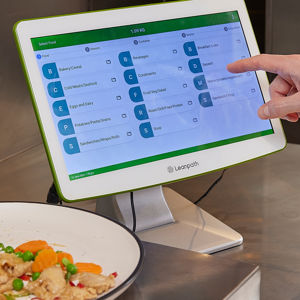 Leanpath technology in action, a person using the touchscreen to log foodwaste