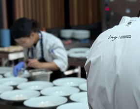 Chef wearing Levy jacket plating up premium food