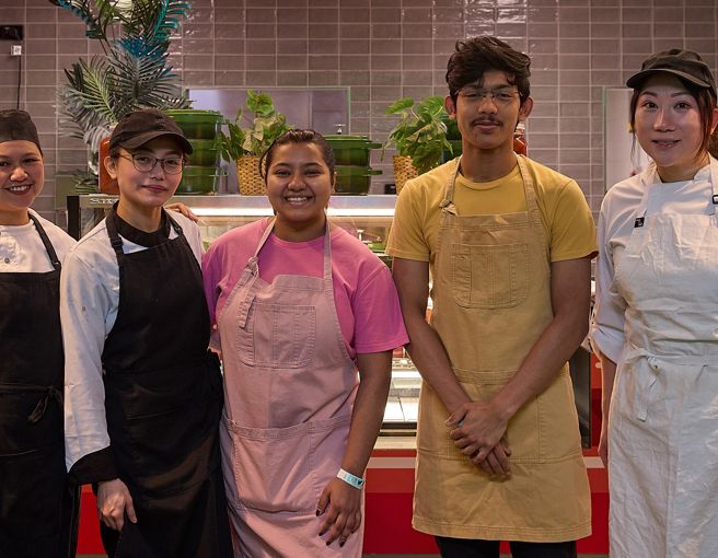 Chefs and front of house staff smiling in a group shot