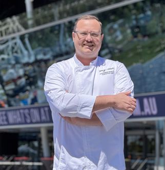 Chef Alex smiling in chef jacket
