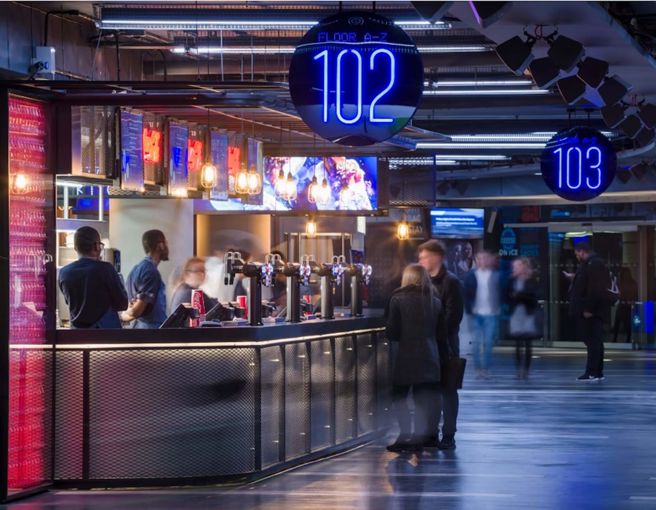 Guests and staff at modern bar venue